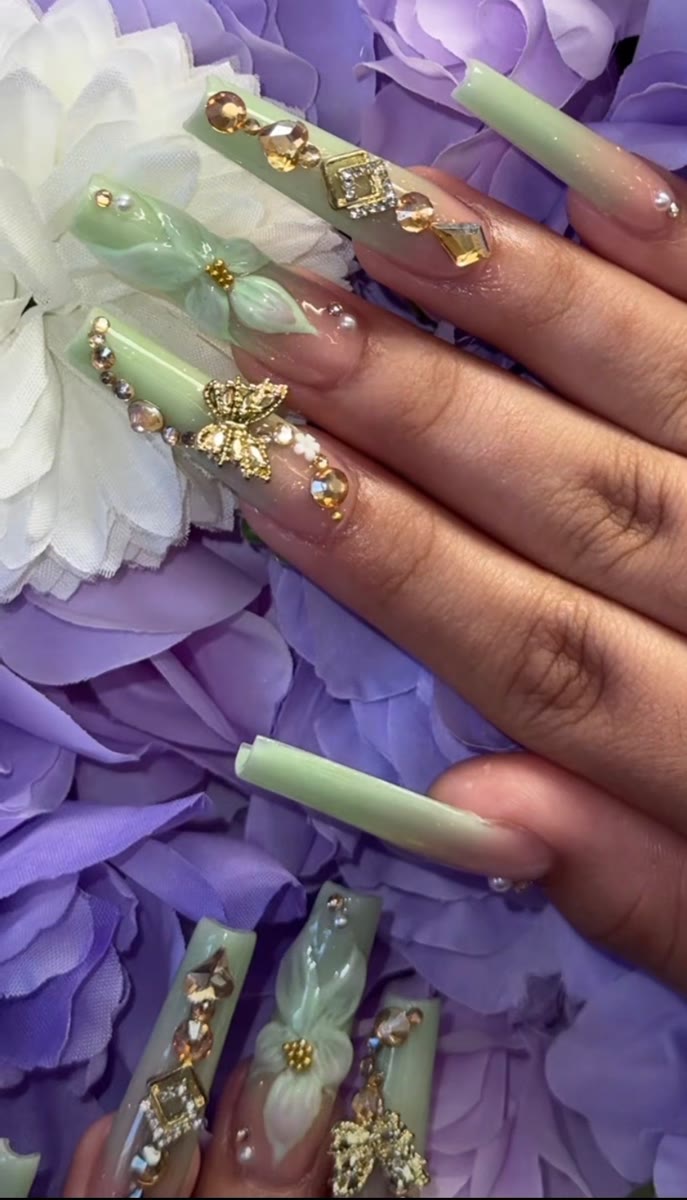 Mint green nails with bows and gold charms